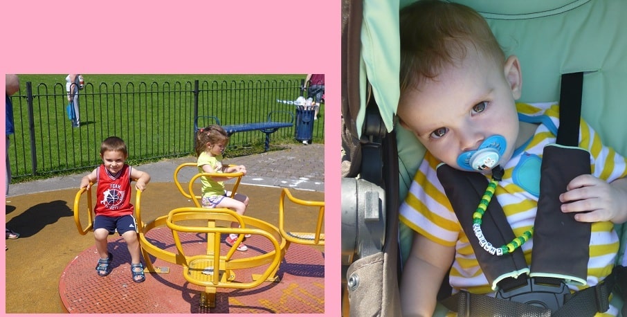 Two young children play on a yellow roundabout at the park, while on the right, a baby with a dummy sits in a pushchair, looking up with wide eyes. The pink background adds to this joyful Family Day scene.