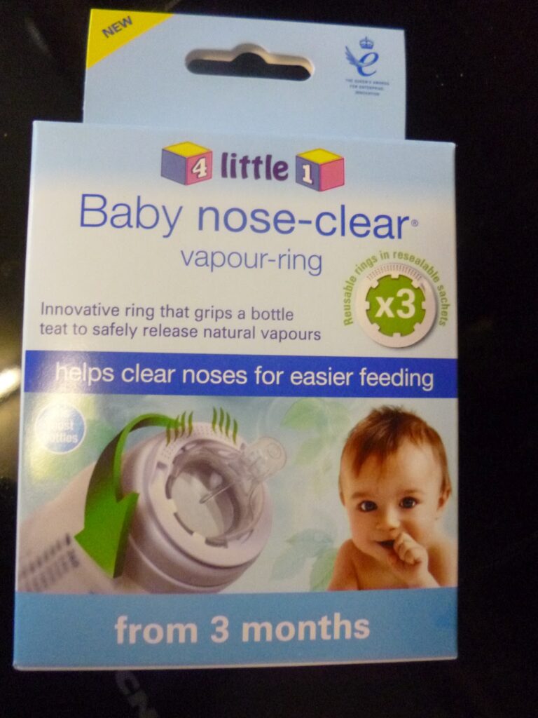 A box of "Baby Nose-Clear Vapour Ring" for infants from 3 months, featuring a baby image, product info, and claims to help clear noses for easier feeding. The box also highlights 3 reusable vapour rings.