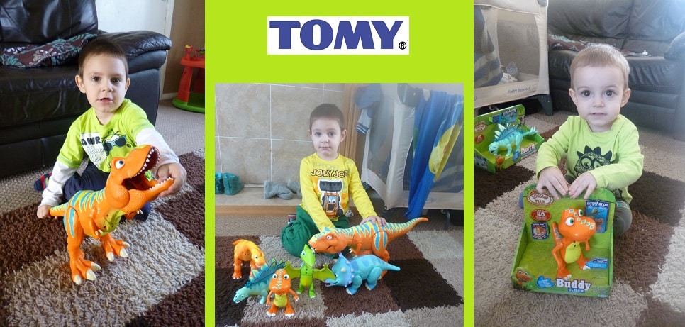 A young boy plays with colourful Dinosaur Toys on the floor, holds one InterAction Figure, and sits with a boxed toy. The TOMY logo appears above the photos on a bright green background.