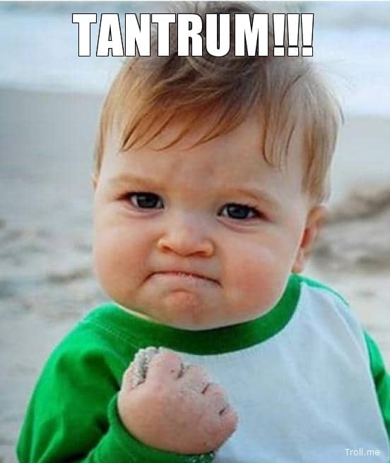A toddler with a determined expression clenches a sand-covered fist at the beach, capturing the raw parenting realities all too familiar to mums and dads. The word "TANTRUM!!!" is boldly written at the top of the image.