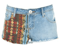 A pair of blue denim shorts with frayed hems, featuring a colourful, patterned fabric panel on one front side—perfect for rest or play.