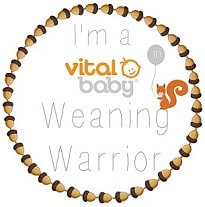A circular badge decorated with acorns around the edge. In the centre, text reads "I'm a vital baby Weaning Warrior" with a smiling face, balloon, and orange squirrel—perfect for sharing weaning tips and celebrating your journey.
