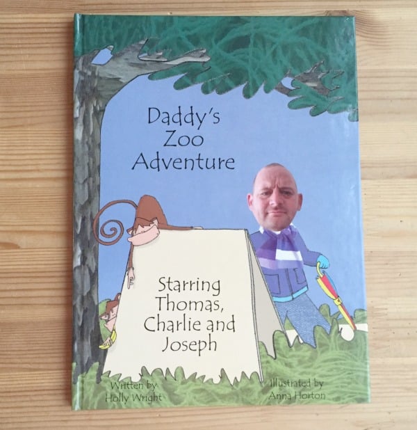 A children's book titled "Daddy's Zoo Adventure" features an illustrated cover with a man's photo edited onto a cartoon body, standing by a tent with a monkey and trees—perfect for Christmas Gift Guide ideas or fun men's Christmas presents. The tent reads "Starring Thomas, Charlie and Joseph.