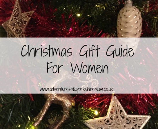 A festive background with gold and silver Christmas tree baubles and tinsel. Overlaid text reads: "Christmas Gift Guide For Women – Gift Ideas for Women www.adventuresofayorkshiremum.co.uk".