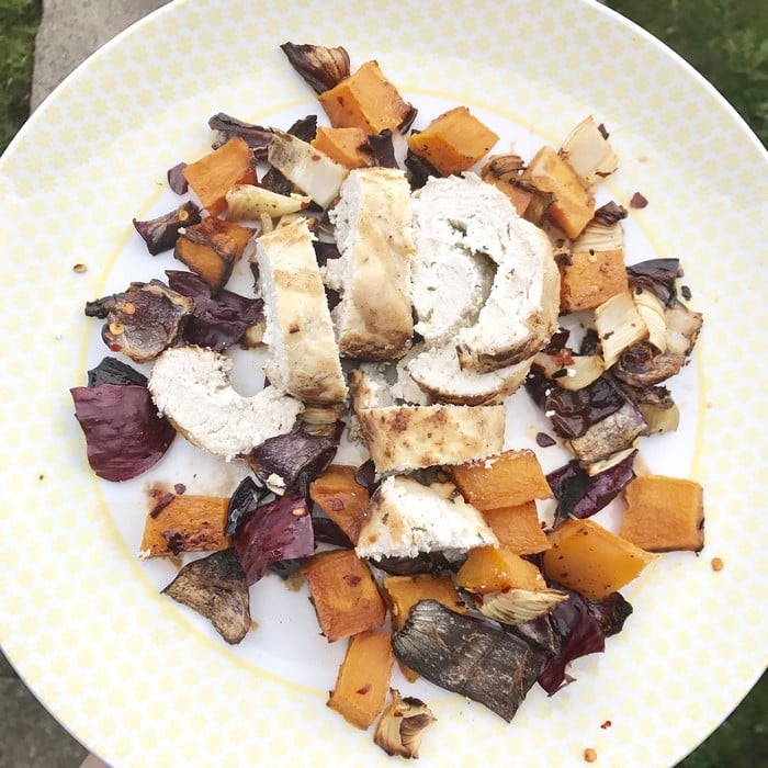 A plate of grilled chicken slices served with roasted vegetables, including red onion, butternut squash, and aubergine, on a yellow-patterned plate—perfect for those seeking Healthy Meals inspired by WW Smart Kitchen.