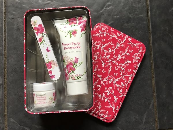 A perfect Mother’s Day gift, this floral red tin includes a hand and nail cream, a small jar, and a nail file—each labelled "Sweet Pea & Honeysuckle" with matching designs. Add it to your gift list for 2017 Mother’s Day celebrations!.