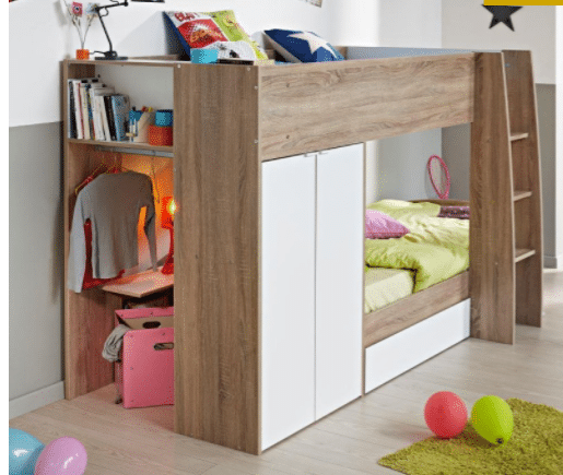 A modern wooden loft bed with a ladder is the highlight of this cosy bedroom, featuring white cupboard doors, a small wardrobe with hanging clothes, books, a lamp, and a pink suitcase underneath. Colourful pillows and balloons brighten the floor nearby.