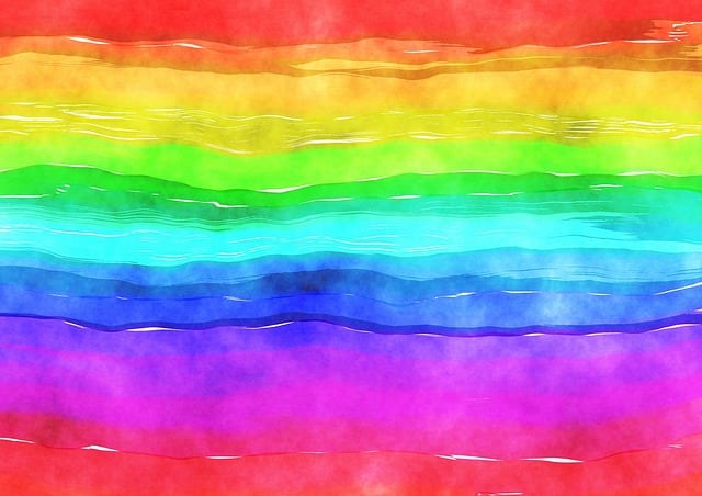A watercolour painting of horizontal rainbow stripes, blending vibrant red, orange, yellow, green, turquoise, blue, and purple shades with a soft, textured appearance—perfect for exploring the benefits of colour in early years.