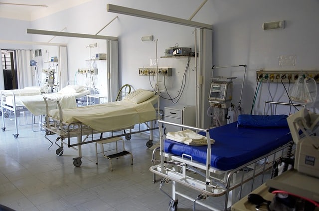 A hospital ward in the UK with several empty beds, medical equipment, and monitors. The clean, well-lit space challenges misconceptions often associated with medical negligence claims through its orderly and professional appearance.