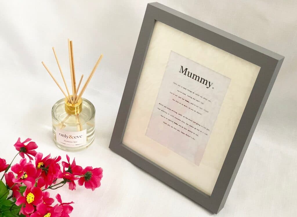 A framed poem titled "Mummy" stands on a white surface next to a glass reed diffuser labelled "only & eve" and a bunch of vibrant pink flowers—an ideal Mother’s Day addition to your 2018 Gift List.