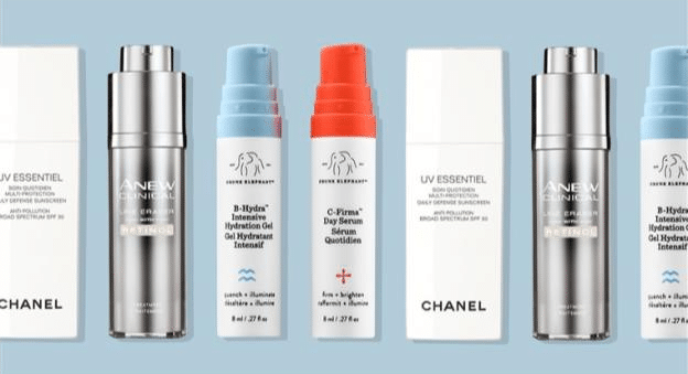 A collection of skincare products from Chanel and Drunk Elephant, including metallic bottles and white cylinders with coloured caps, beautifully arranged against a light blue background—perfect birthday gift ideas for Mum.