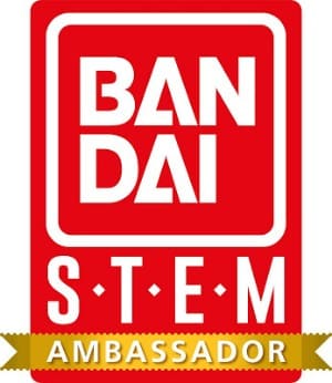 Red and white Bandai logo above the text "STEM" in capital letters. A gold ribbon at the bottom contains the word "Ambassador" in white letters, highlighting expertise with Bandai STEM Kits like Crystal Growing or Sea Monkeys.