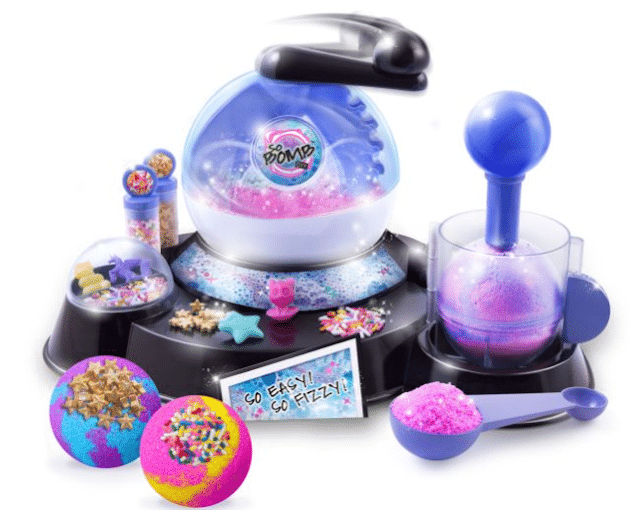 A colourful DIY bath bomb making kit with mixing stations, moulds, glitter, sprinkles, two finished bath bombs, and tools displayed on a black and purple base. This fun educational toy encourages cognitive development—so easy, so fizzy!.