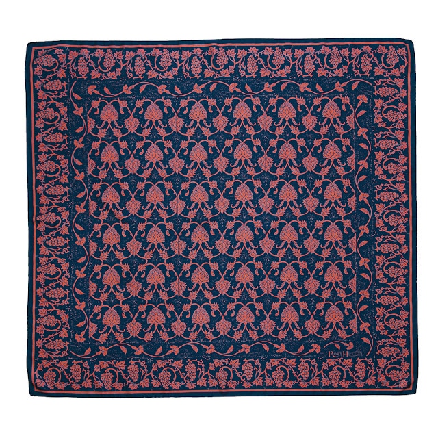 A square fabric scarf with a navy blue background and intricate pink floral and vine patterns arranged in symmetrical rows, bordered by a decorative floral edge—perfect for Mother’s Day or as part of a UK Bloggers Prize Bundle Giveaway.