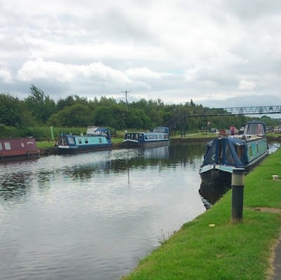 a number of canal boats docked in a canal