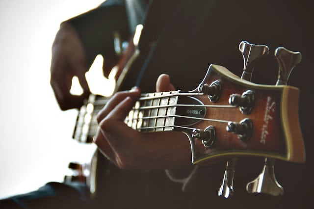 A person playing an electric guitar