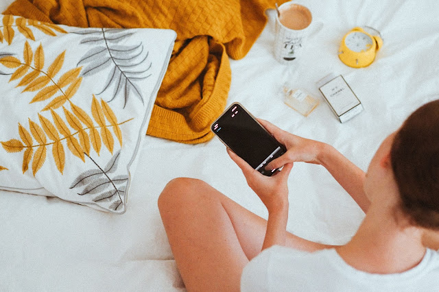 An Influencer taking a flat lay photograph of some perfume