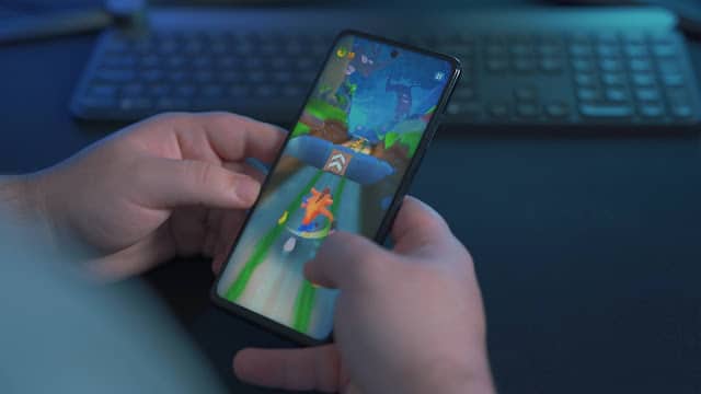 A person playing Crash Bandicoot on their mobile phone