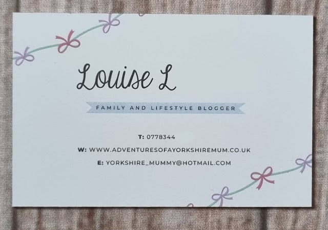 A business card for Louise L, family and lifestyle blogger, with pastel ribbon designs. Features her website, phone, email—and makes a wonderful example for anyone seeking an Aura Print review or business card review.