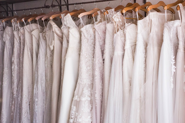 A rail of wedding dresses in a shop