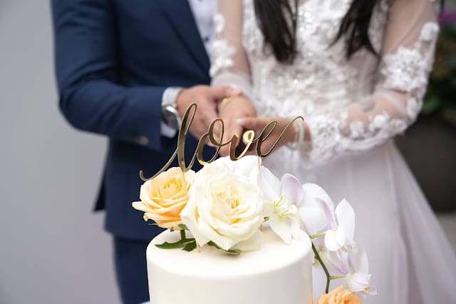 A couple cutting their wedding cake