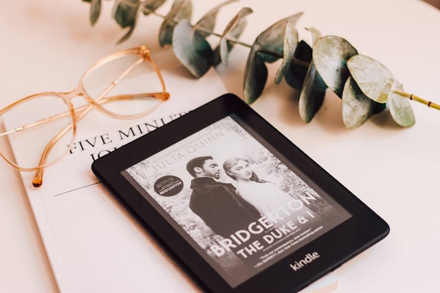A Kindle showing a Bridgerton book on the cover