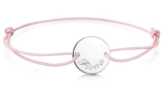 A delicate pink cord bracelet featuring a round silver charm engraved with the name "Fiona"—a thoughtful choice for Christmas presents for adults.