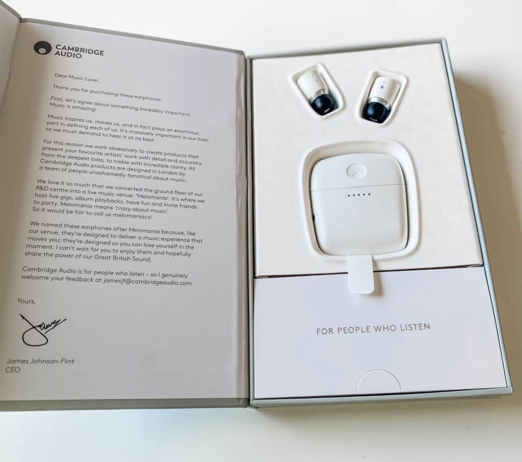 Open box with a letter on the left and a set of white wireless earphones with a charging case on the right; text reads "For People Who Listen." Perfect for our summer prize giveaway.