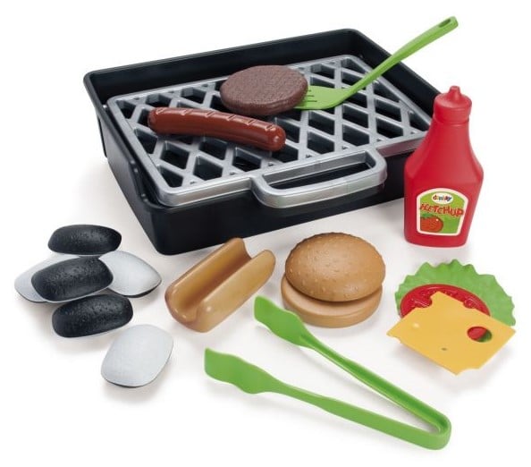 The Dantoy barbecue playset features a plastic toy grill with toy food, including a hamburger patty, hot dog, bun, lettuce, cheese, ketchup bottle, tongs, spatula, and black and white charcoal pieces.