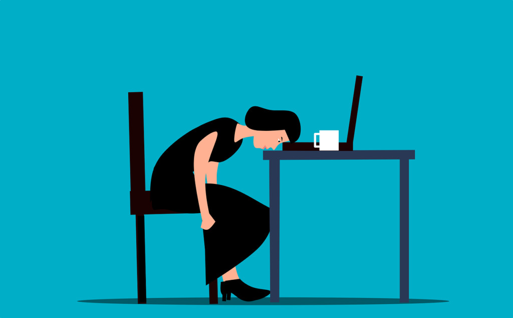 A woman sits slumped on a chair with her head down on a desk in front of a laptop and coffee cup, appearing exhausted or overwhelmed—illustrating why digital clutter matters—against a plain blue background.