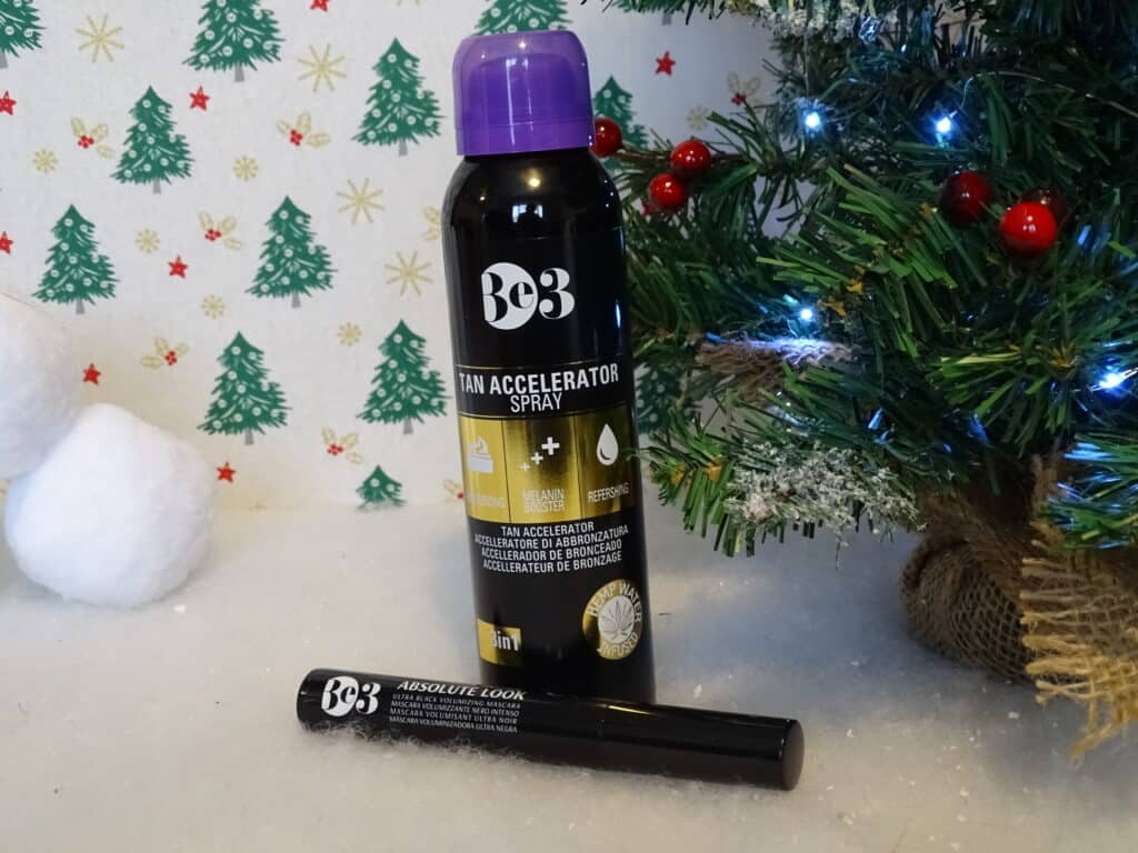 A spray can of fake tan and a wand of mascara