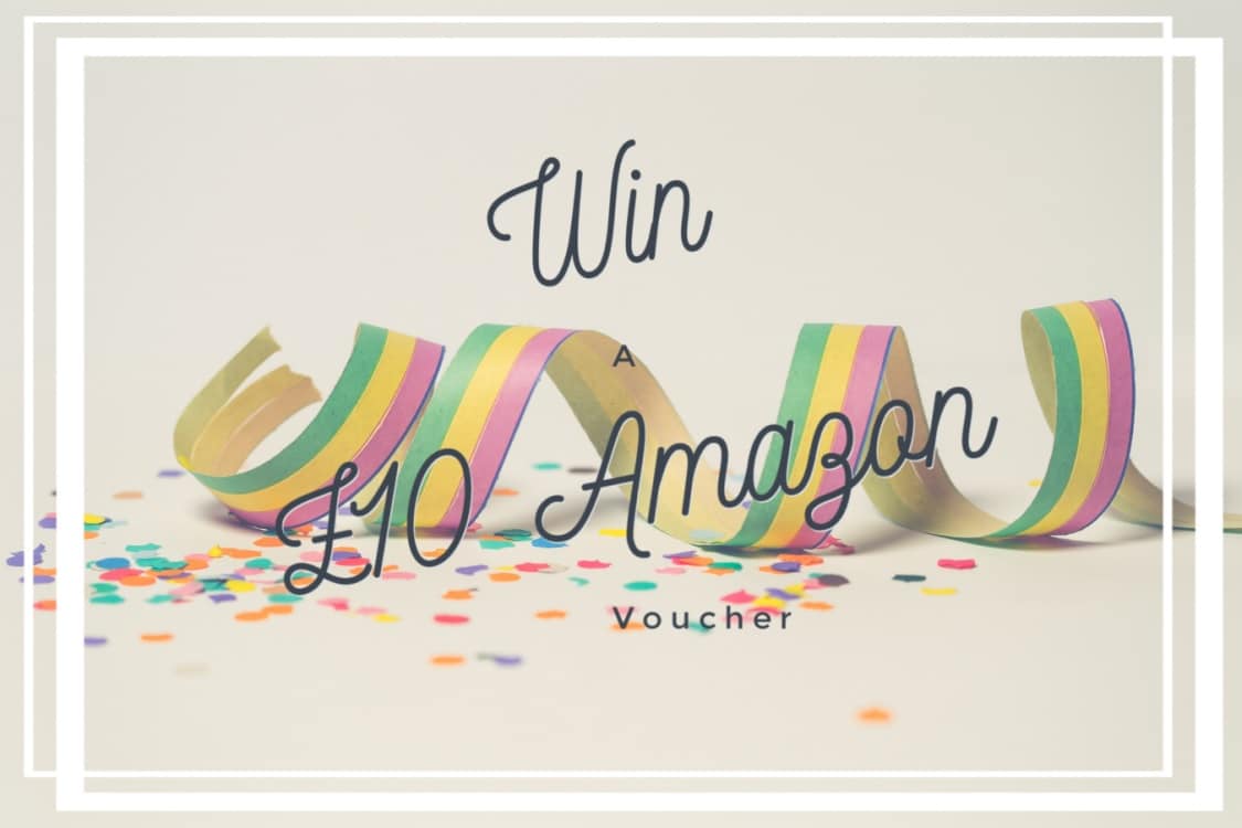Colourful party streamers and confetti surround the elegant script text overlay: "Win A £10 Amazon Voucher," all beautifully framed by crisp white borders.