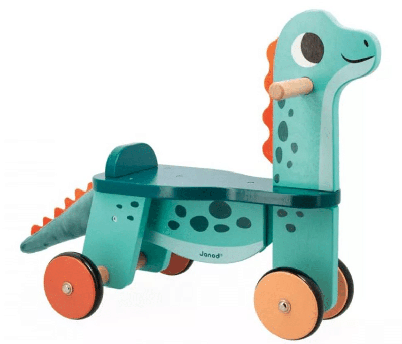 A turquoise ride-on wooden toy shaped like a dinosaur with orange accents, four wheels, a long neck, a smiling face, and black spots—perfect for children who love must-have Unicorn and Dinosaur toys.