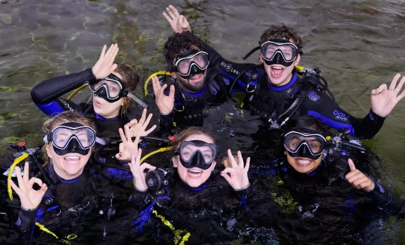 A family of 6 people taking part in a diving gift experience