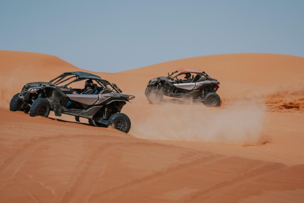Two Dune Buggies racing in the sand in Dubai