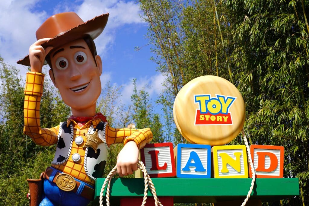 Toy Story Land signpost with a giant cowboy Woody figure