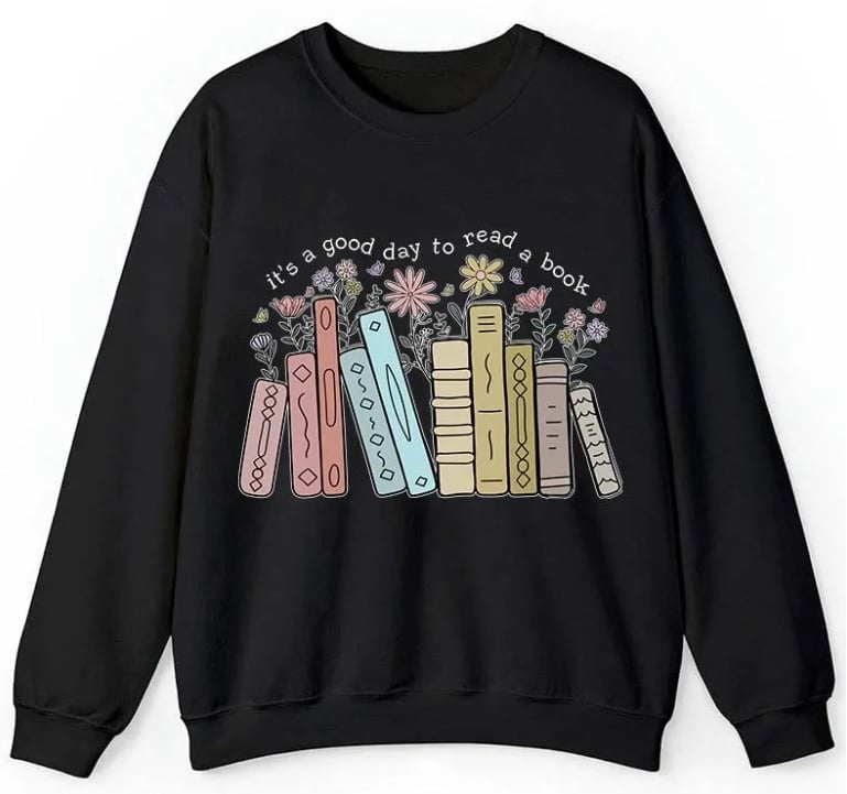 A black jumper featuring colourful illustrated books and flowers, with the text "it's a good day to read a book" above the books—perfect for any book-loving teacher.