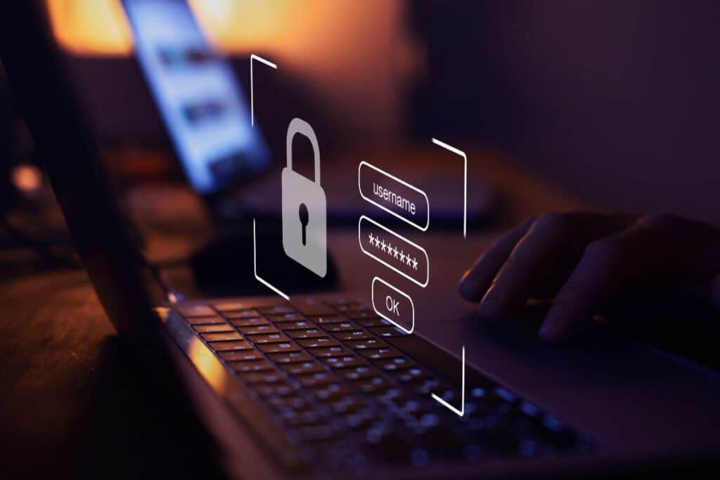A person typing on a laptop with a digital overlay showing a padlock icon and login fields, symbolising cybersecurity, secure access, and the importance of CISMP training for safeguarding information.