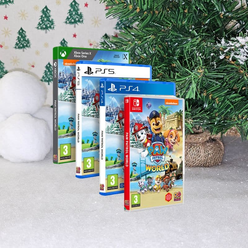 Four video game cases (Xbox, PS5, PS4, Nintendo Switch) for “PAW Patrol World” are displayed standing in a row on a snowy surface, with Christmas decorations—a festive tree and snowball props—in the background.