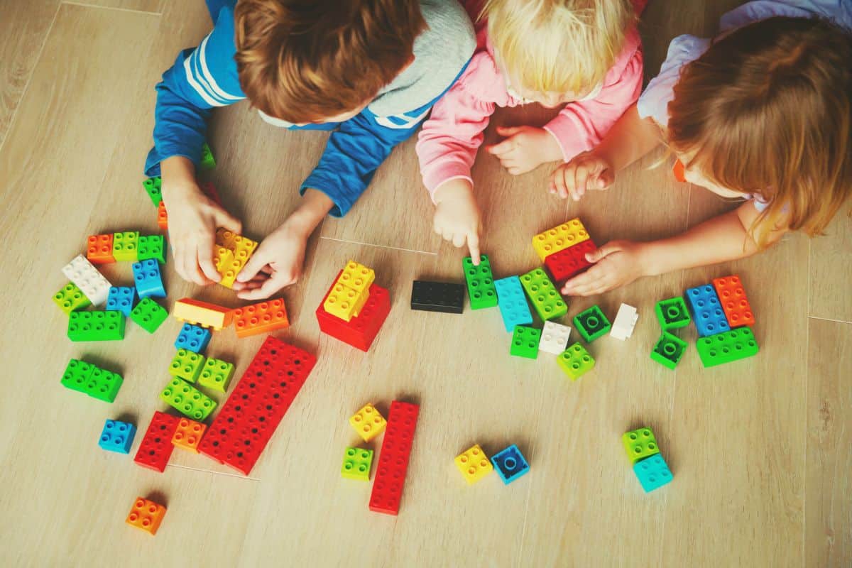 three children taking part in unstructured play which helps with child development