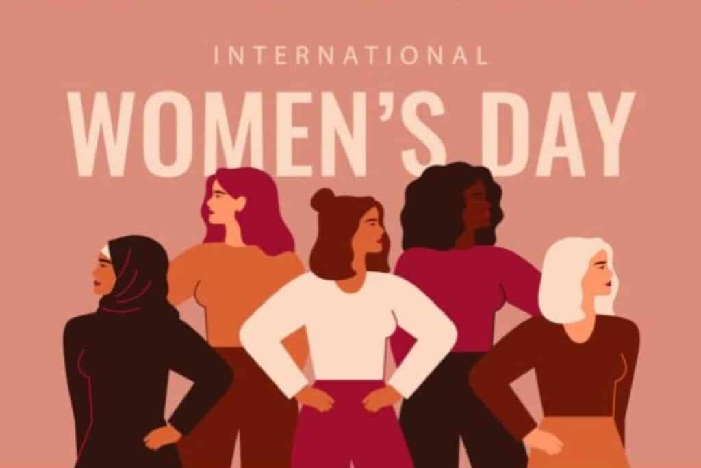 Illustration of five diverse women standing confidently with hands on hips beneath the words "International Women's Day" on a pink background, celebrating women's day and empowerment.