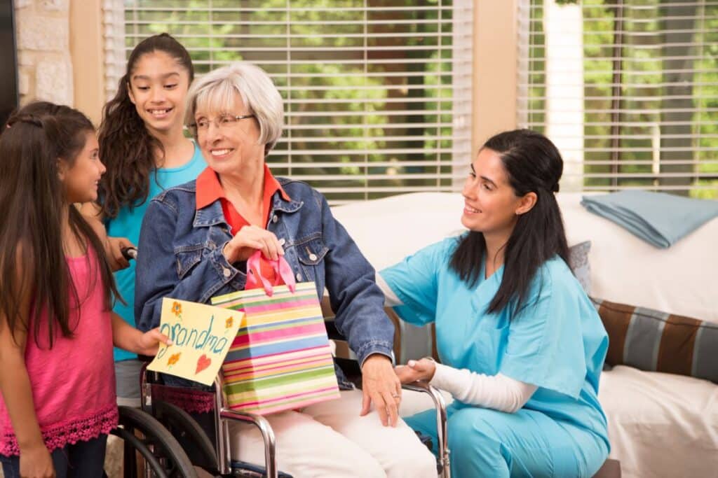a family visiting a relative in a care home setting