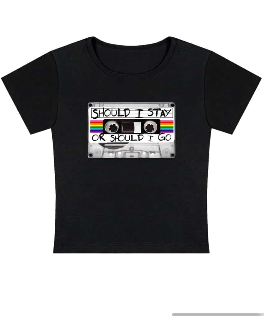 A black fashion t-shirt featuring a graphic of a cassette tape with colourful stripes and the words "Should I Stay Or Should I Go" written on the tape label.