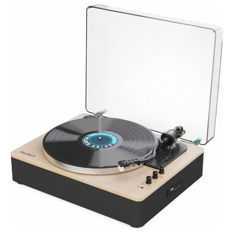 A modern turntable with a transparent dust cover, playing a black vinyl record. The light wood base features control knobs and a speaker on the front—an ideal Father’s Day present for music-loving dads.
