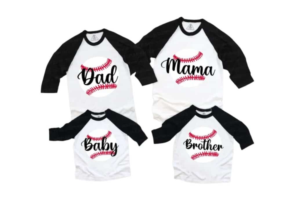 Four white and black raglan family shirts are arranged together, each featuring a red baseball graphic and text: "Dad," "Mum," "Baby," and "Brother." The shirts are laid out on a white background.