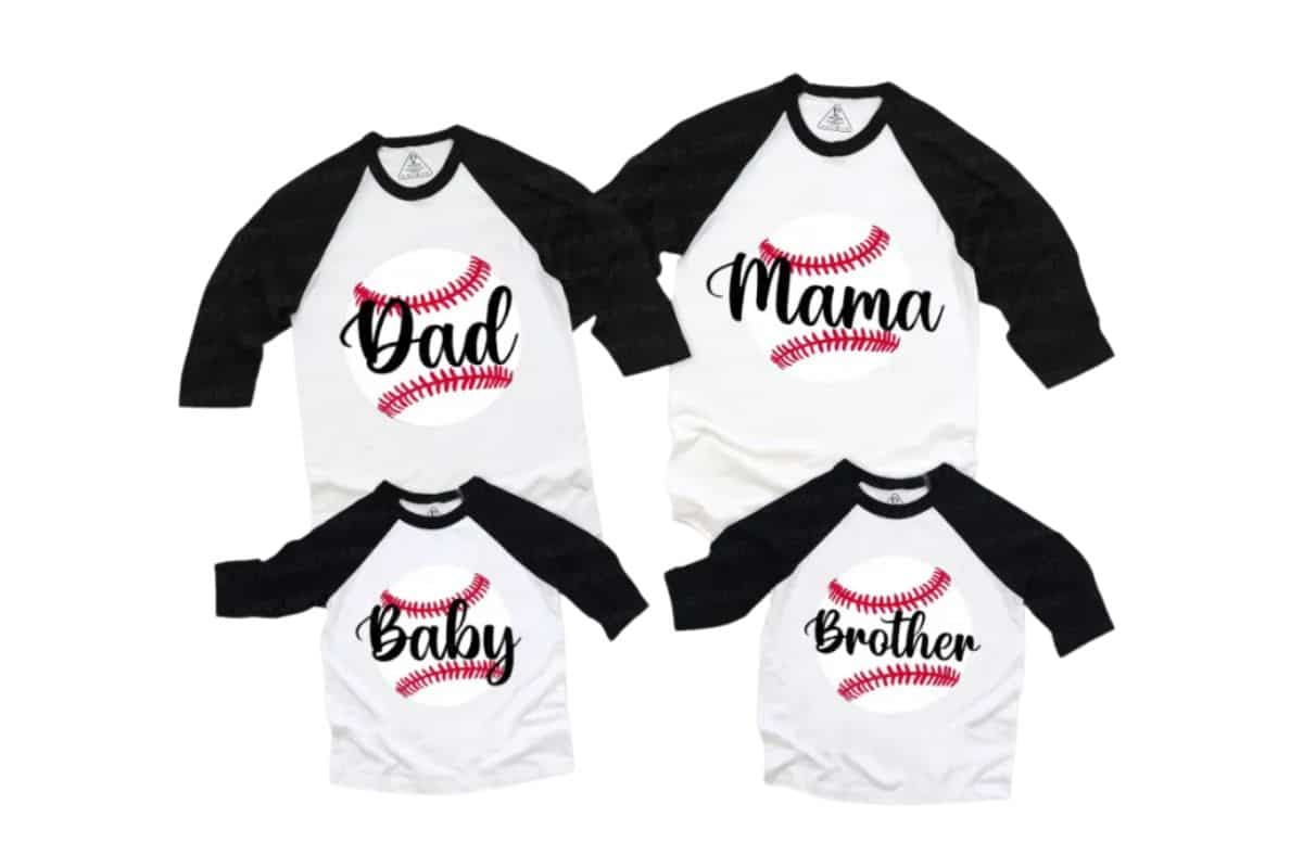 Four white and black raglan family shirts are arranged together, each featuring a red baseball graphic and text: "Dad," "Mum," "Baby," and "Brother." The shirts are laid out on a white background.